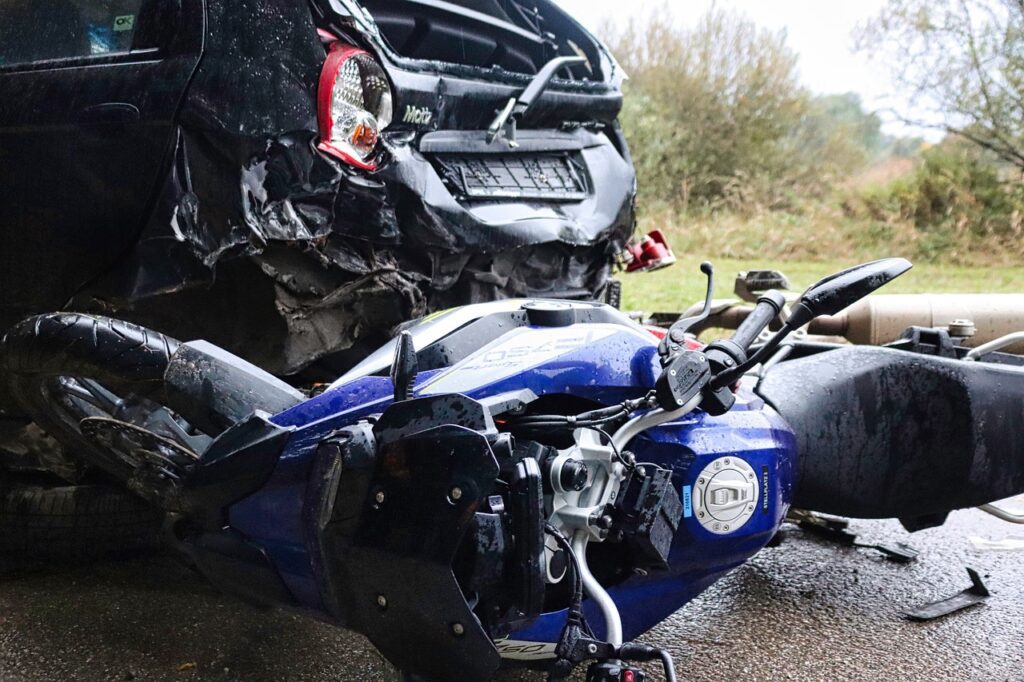 Crashed vehicle and motorcycle along the road following incident
