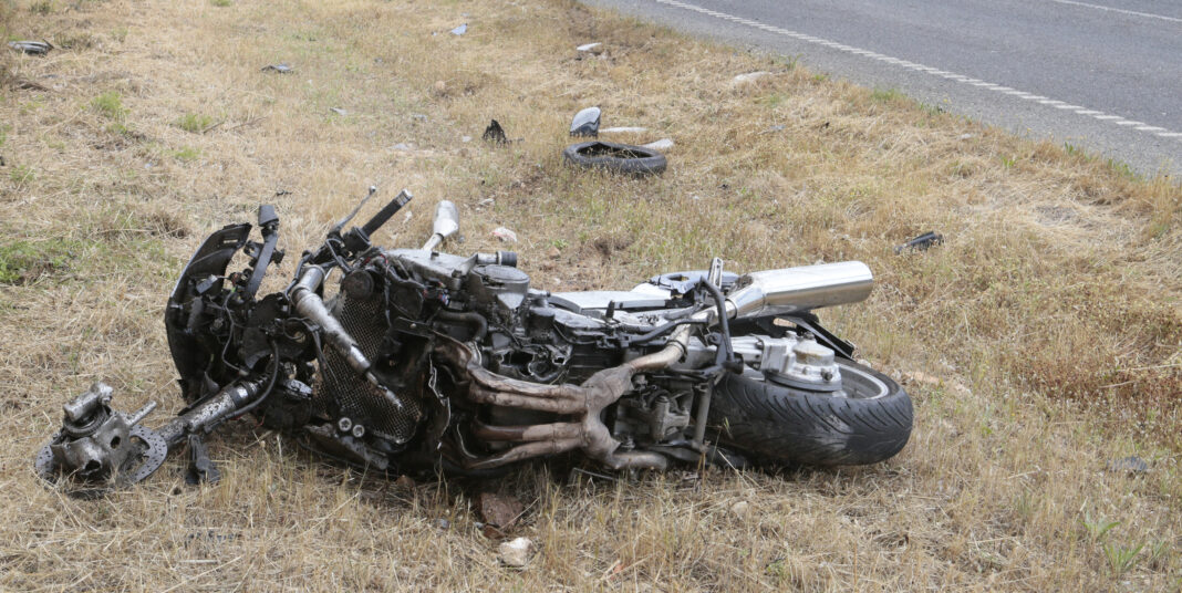 dreamstime_l_118032130 Crashed motorcycle scattered on side of road