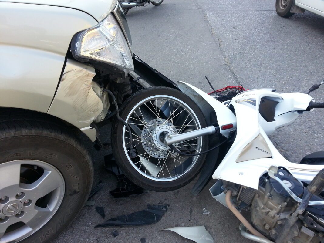 dreamstime_l_54772739 Crashed motorcycle on ground following car accident