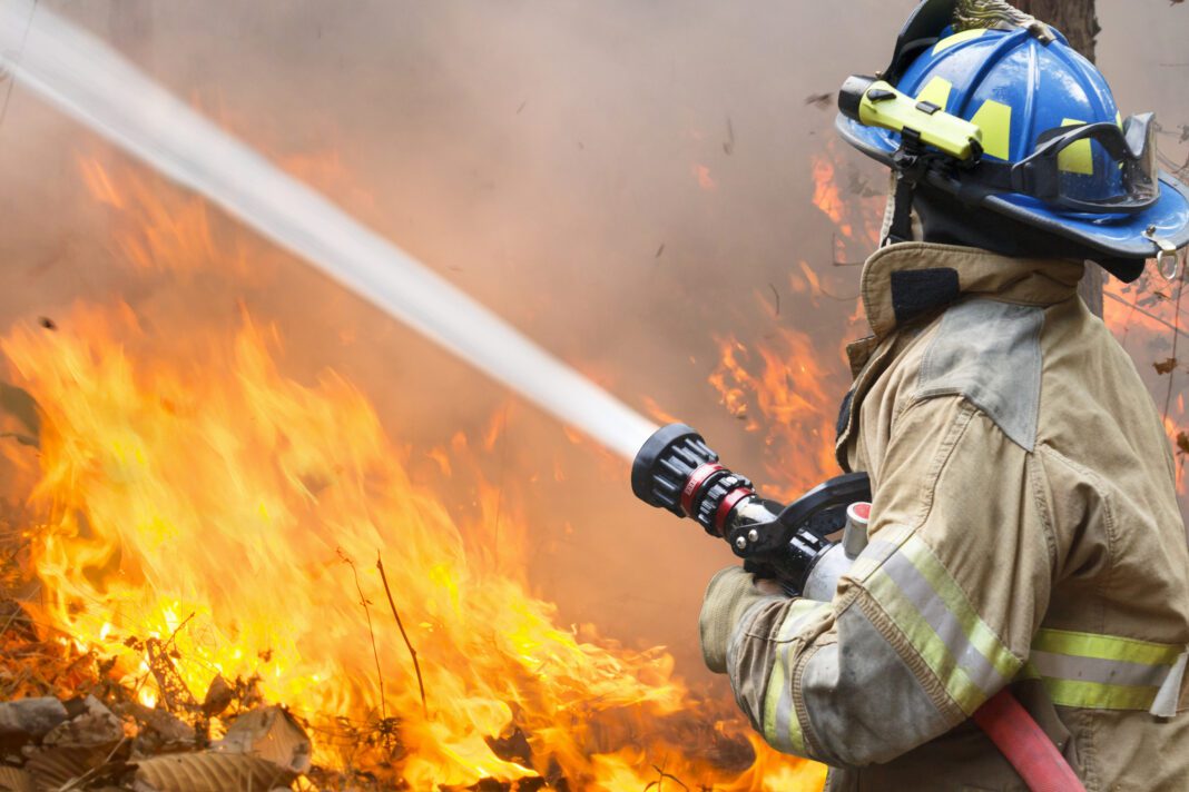 large-blaze firefighter attempting to put out large blaze is depicted