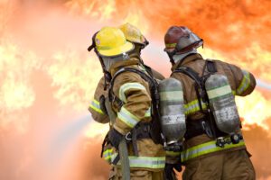 firefighters attempt to extinguish large flames